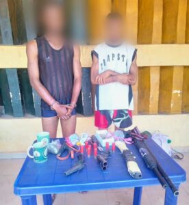 Two of the paraded suspects and recovered guns